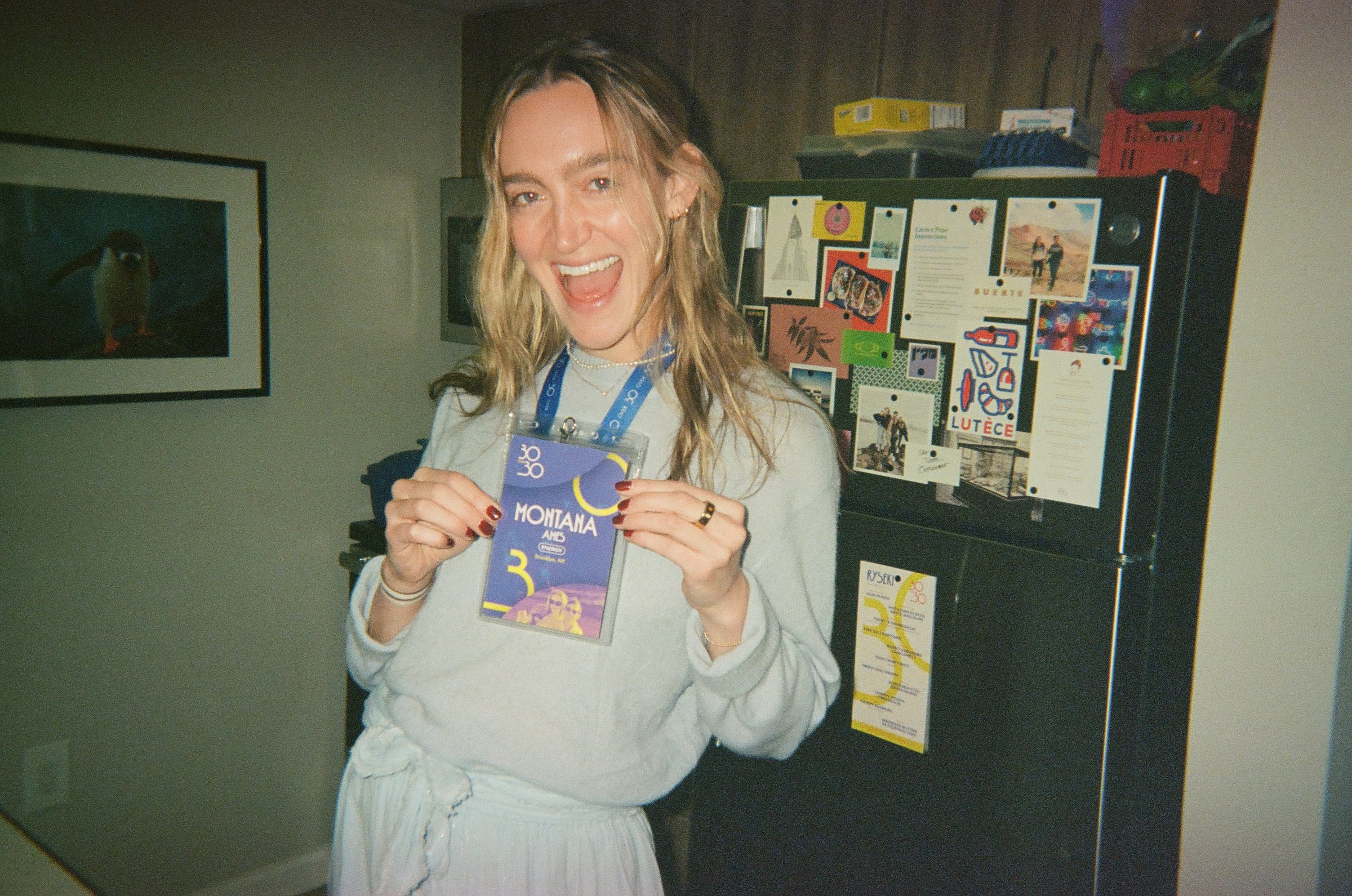 Guest holding a 30 Over 30 badge
