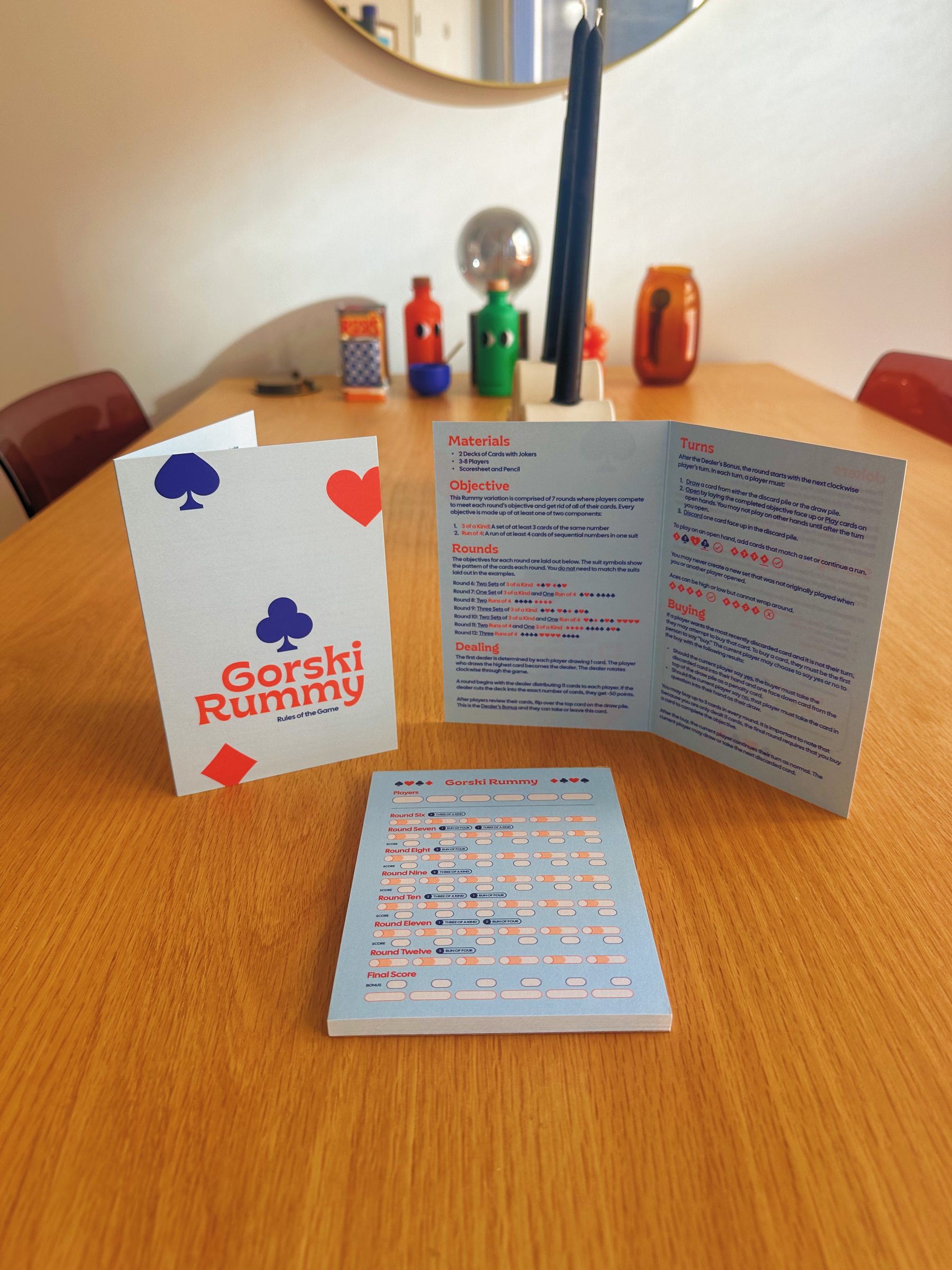 Styled photo of the Gorski Rummy rulebook and score pad