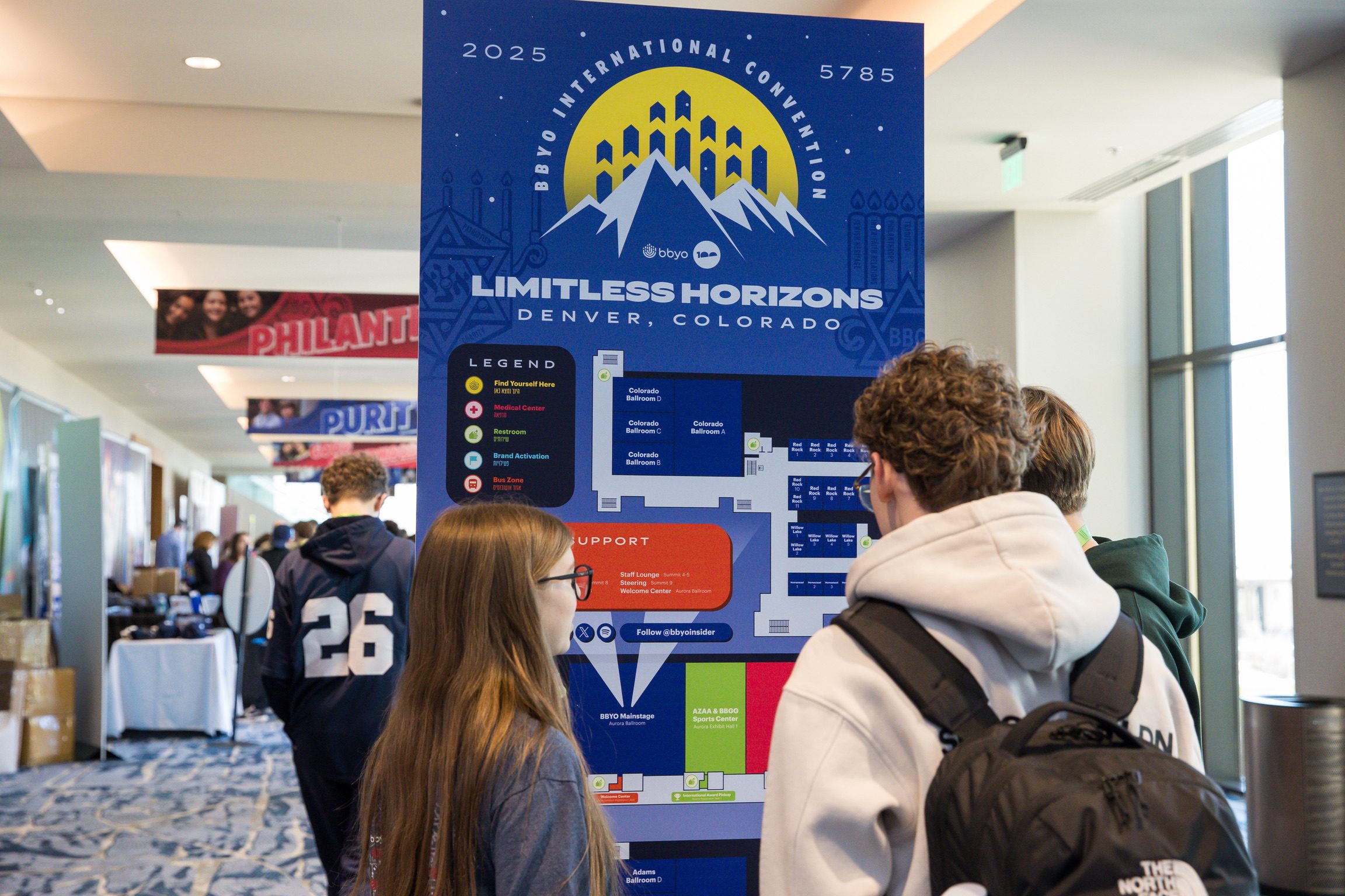 Attendees reading the convention wayfinding sign
