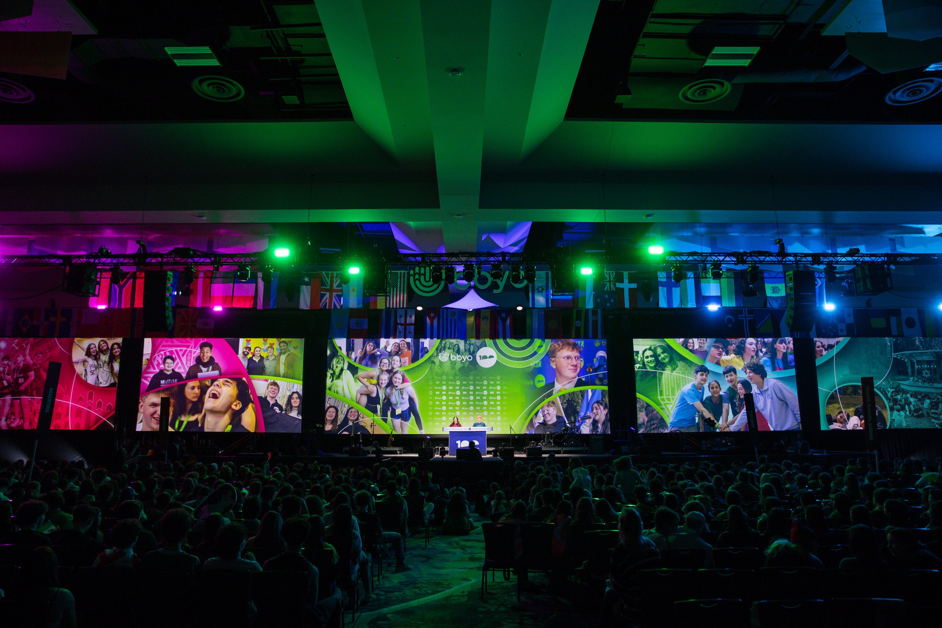 Plenary session at BBYO International Convention 2025 with branded stage screens