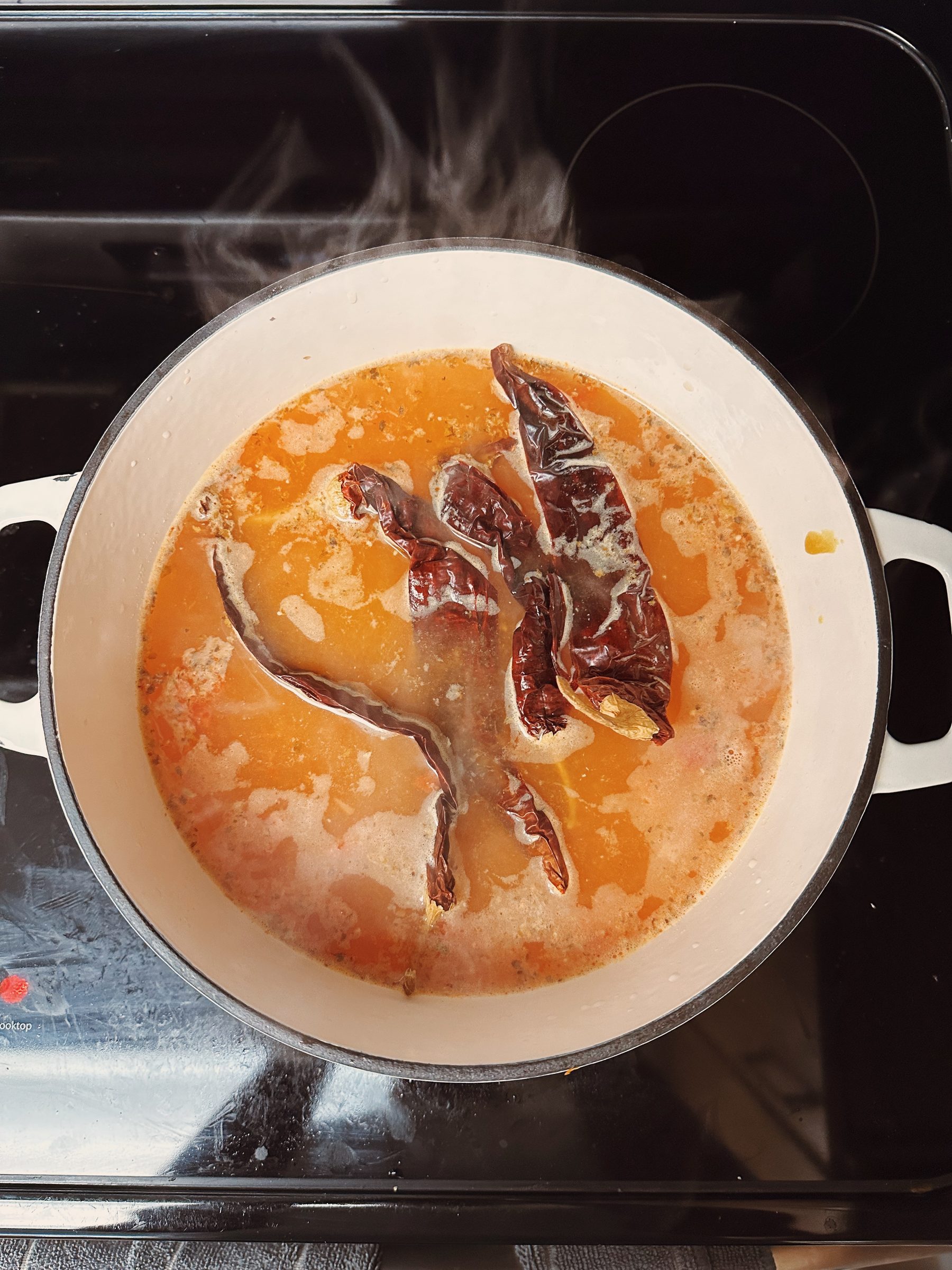 Simmering guajillo chiles on the stove