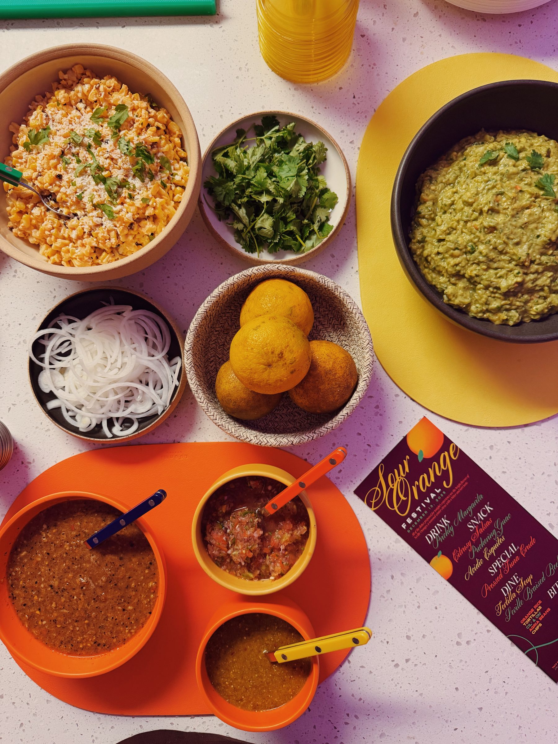 Taco Night Collective spread with elote, guacamole, salsas, and the Sour Orange Festival menu